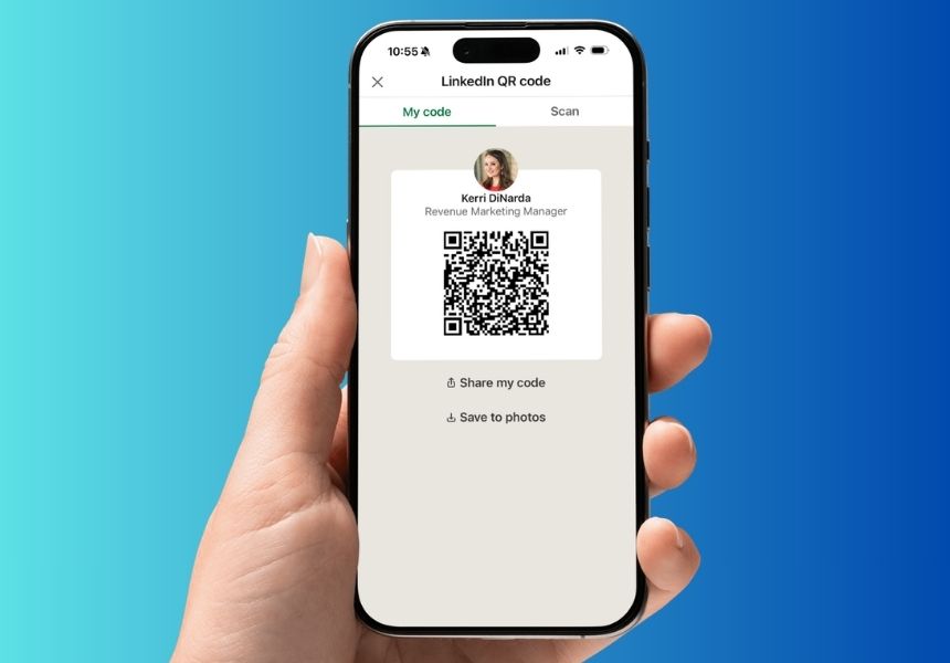 A phone with a LinkedIn QR code for sharing shown on its screen