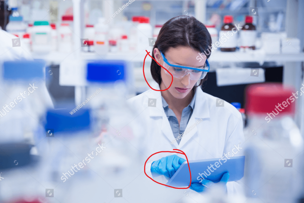 the same image of a scientist in lab using a tablet with gloves on and hair not tied back, and with the problem areas circled in red
